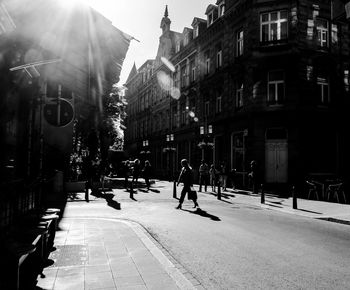 People walking on street amidst buildings in city