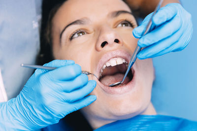 Dentist operating boy in medical clinic