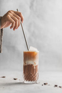 Close-up of hand holding coffee cup