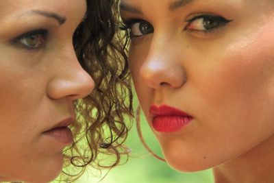 Close-up portrait of lesbian woman with girlfriend outdoors