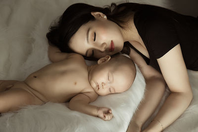 Close-up of baby sleeping on bed