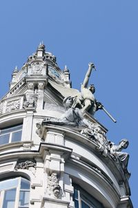 Low angle view of traditional building against clear blue sky