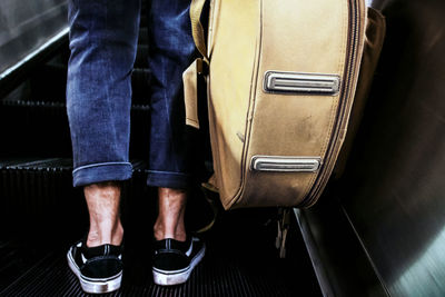 Low section of man standing on train