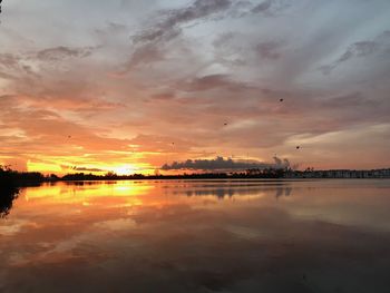 Scenic view of lake against sky during sunset