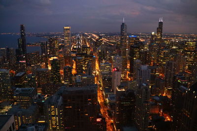 Prime - illuminated cityscape against sky at night