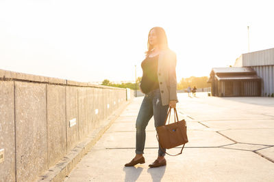 Full length of young woman walking outdoors