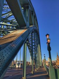 Low angle view of bridge against clear blue sky