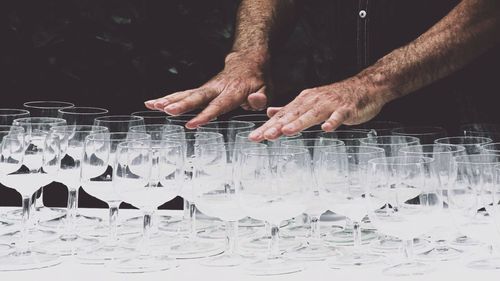 Cropped image of man hands over wine glasses