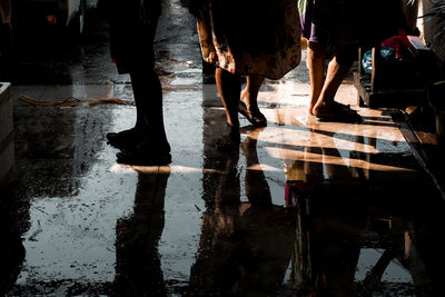 Low section of people on wet footpath