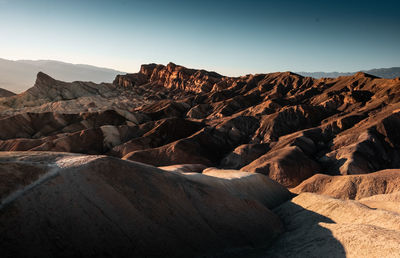 Scenic view of arid landscape against clear sky