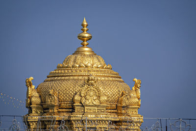 Intricately carved golden dome of famous tirupati temple in andhra pradesh, india.