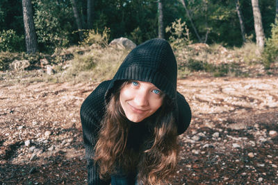 Portrait of beautiful young woman in forest