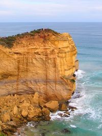 Rock formation on sea against sky
