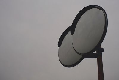 Low angle view of information sign against sky