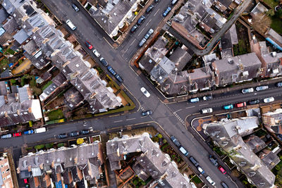 Aerial view directly above of the rooftops of back to back terraced houses and road junction