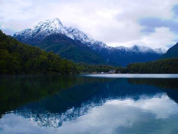 Scenic view of snowcapped mountain against cloudy sky