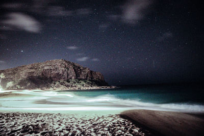Scenic view of sea against sky at night