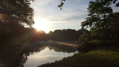 Scenic view of lake against sky at sunset