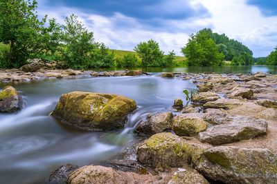 Scenic view of waterfall against sky