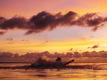 Scenic view of sea against orange sky