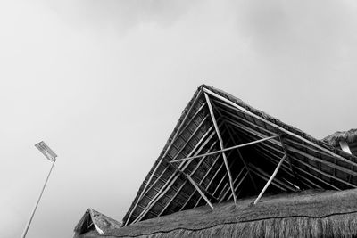 Low angle view of building roof against sky