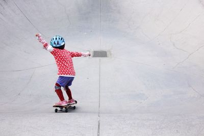 High angle view of child with skateboard on ramps