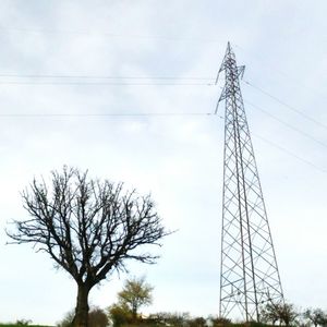 Low angle view of electricity pylon against sky