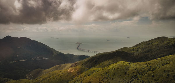 Panoramic view of land and mountains against sky