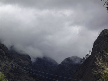 Scenic view of mountains against cloudy sky
