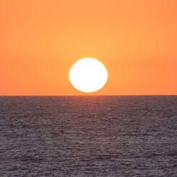 Scenic view of sea against orange sky