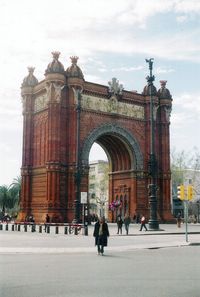 People walking in front of historical building