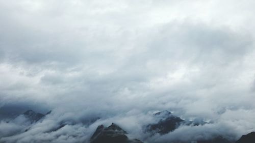 Scenic view of mountains against cloudy sky