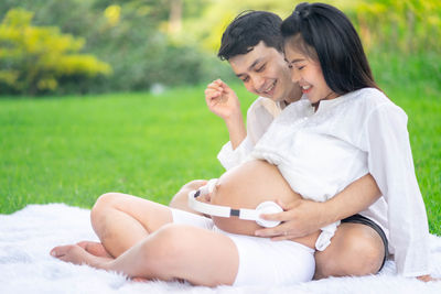 Young couple sitting outdoors