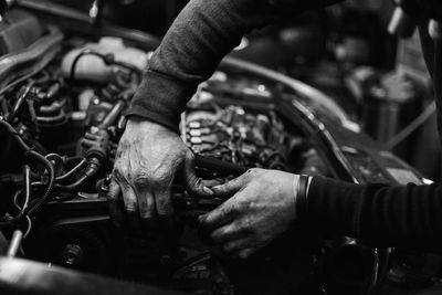 Close-up of man working on motorcycle