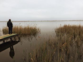 Two people standing in lake