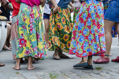 Low section of people dancing samba on street