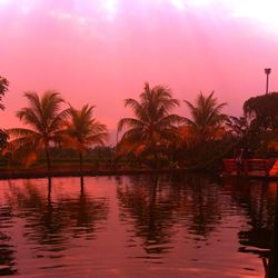 Scenic view of lake against sky at sunset