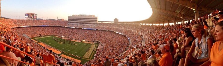 Panoramic view of crowd in city against sky