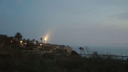View of fence against sky at dusk