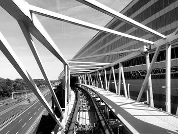 Bridge over road in city against sky