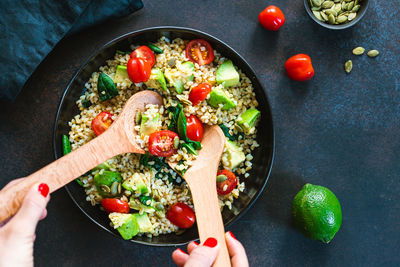 Cropped hands of woman preparing food on table