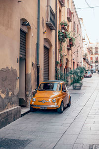 Car on street by buildings