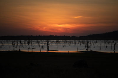 Scenic view of lake against romantic sky at sunset