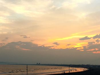 Scenic view of beach against sky during sunset