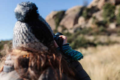 Rear view of woman photographing