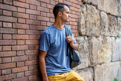 Man leaning against wall