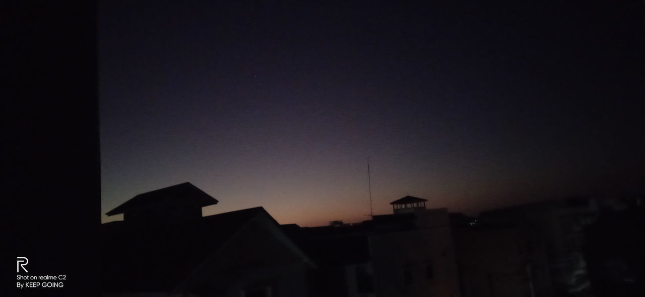 LOW ANGLE VIEW OF SILHOUETTE BUILDINGS AGAINST CLEAR SKY AT SUNSET