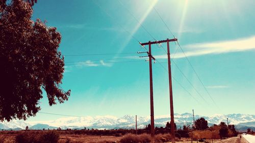 Low angle view of electricity pylon against sky