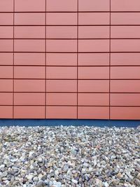 Pebbles and red tiled wall facade