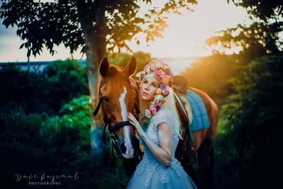 Woman wearing mask against trees and plants